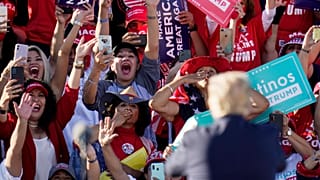 President Donald Trump acknowledges the cheering crowd behind him at a campaign rally at Phoenix Goodyear Airport Wednesday, Oct. 28, 2020, in Goodyear, Arizona.