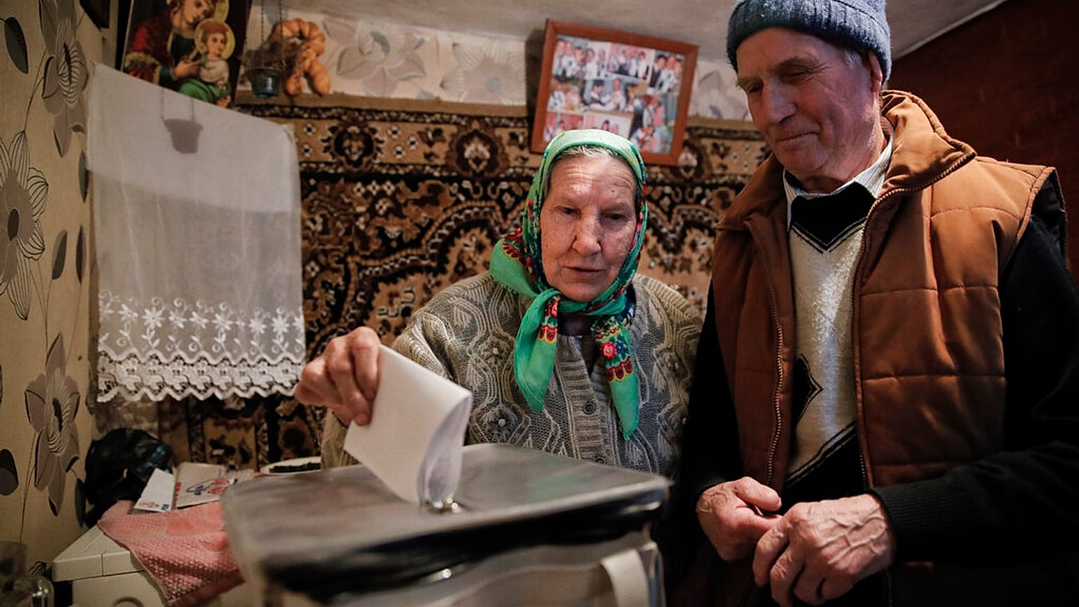 A woman casts her vote in a mobile ballot box in the village of Stolniceni, Moldova, Sunday, Feb. 24, 2019. 
