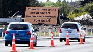 In this Oct. 16, 2020, file photo, cars are driven past a billboard urging voters to vote "No" against euthanasia in Christchurch, New Zealand