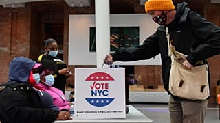 A voter drops off his early voting ballot for the 2020 Presidential election at the Brooklyn Museum in New York City on October 30, 2020.