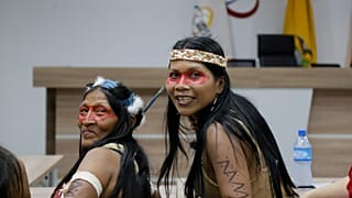 Waoranis leader Nemonte Nenquimo, center right, waits for the start of a hearing on a lawsuit in Puyo, Ecuador.