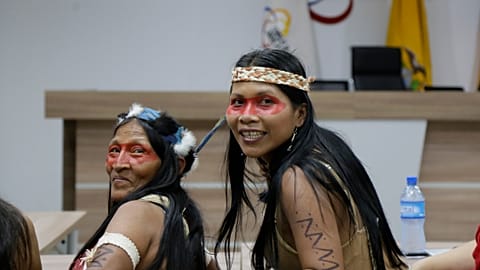 Waoranis leader Nemonte Nenquimo, center right, waits for the start of a hearing on a lawsuit in Puyo, Ecuador.