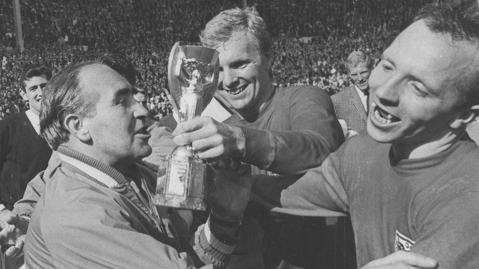 FILE - In this July 30, 1966 file photo, Nobby Stiles, right, looks at the Jules Rimet Cup, held by England captain Bobby Moore after they had won the trophy 