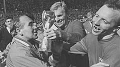 FILE - In this July 30, 1966 file photo, Nobby Stiles, right, looks at the Jules Rimet Cup, held by England captain Bobby Moore after they had won the trophy 