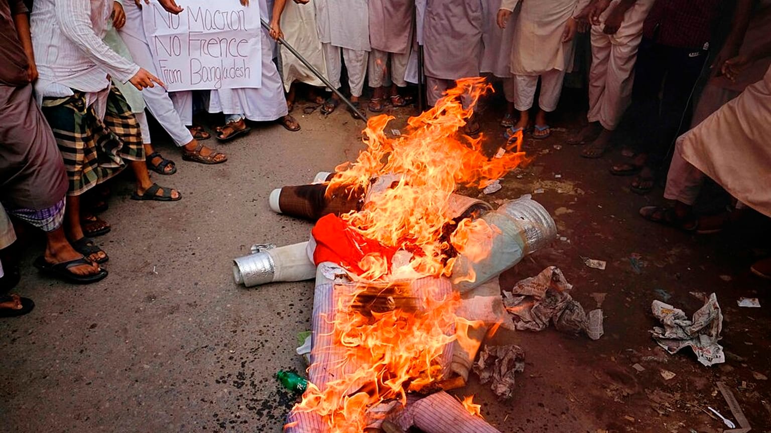Supporters of Islami Oikya Jote, an Islamist political party, burn an effigy representing French President Emmanuel Macron during a protest in Dhaka, Bangladesh