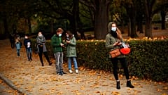 People observing social distancing wait in line to be tested in a Red Cross COVID-19 test centre at Cinquantenaire park in Brussels. Monday, Oct. 19, 2020.
