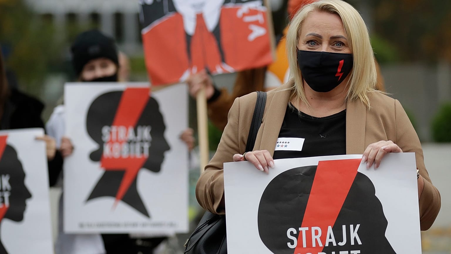 Women's rights activists with posters of the Women's Strike action protest against recent tightening of Poland's restrictive abortion law.