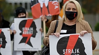 Women's rights activists with posters of the Women's Strike action protest against recent tightening of Poland's restrictive abortion law.