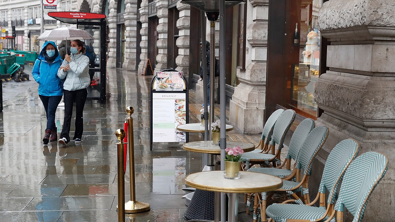 People wearing masks to help prevent the spread of the coronavirus walk along Regent Street, one of the main shopping streets in London, Thursday, Oct. 29, 2020.