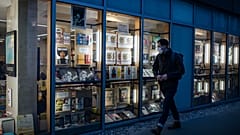 A masked man walks by a bookstore in Paris, Thursday October 29, 2020.