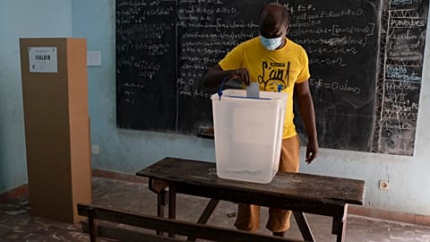 A man casts his vote during presidential election in Abidjan, Ivory Coast, Saturday, Oct. 31, 2020