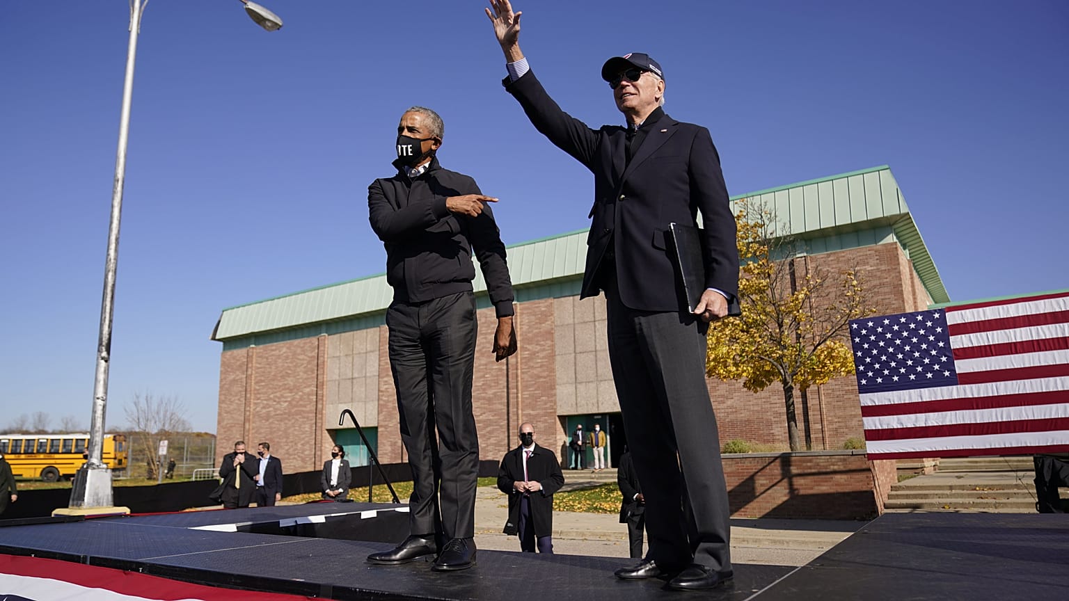 Democratic presidential candidate Joe Biden, right, and former President Barack Obama greet each other at a rally at Northwestern High School in Flint, Michigan.