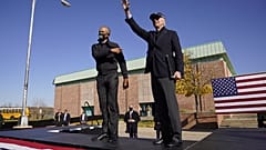 Democratic presidential candidate Joe Biden, right, and former President Barack Obama greet each other at a rally at Northwestern High School in Flint, Michigan.
