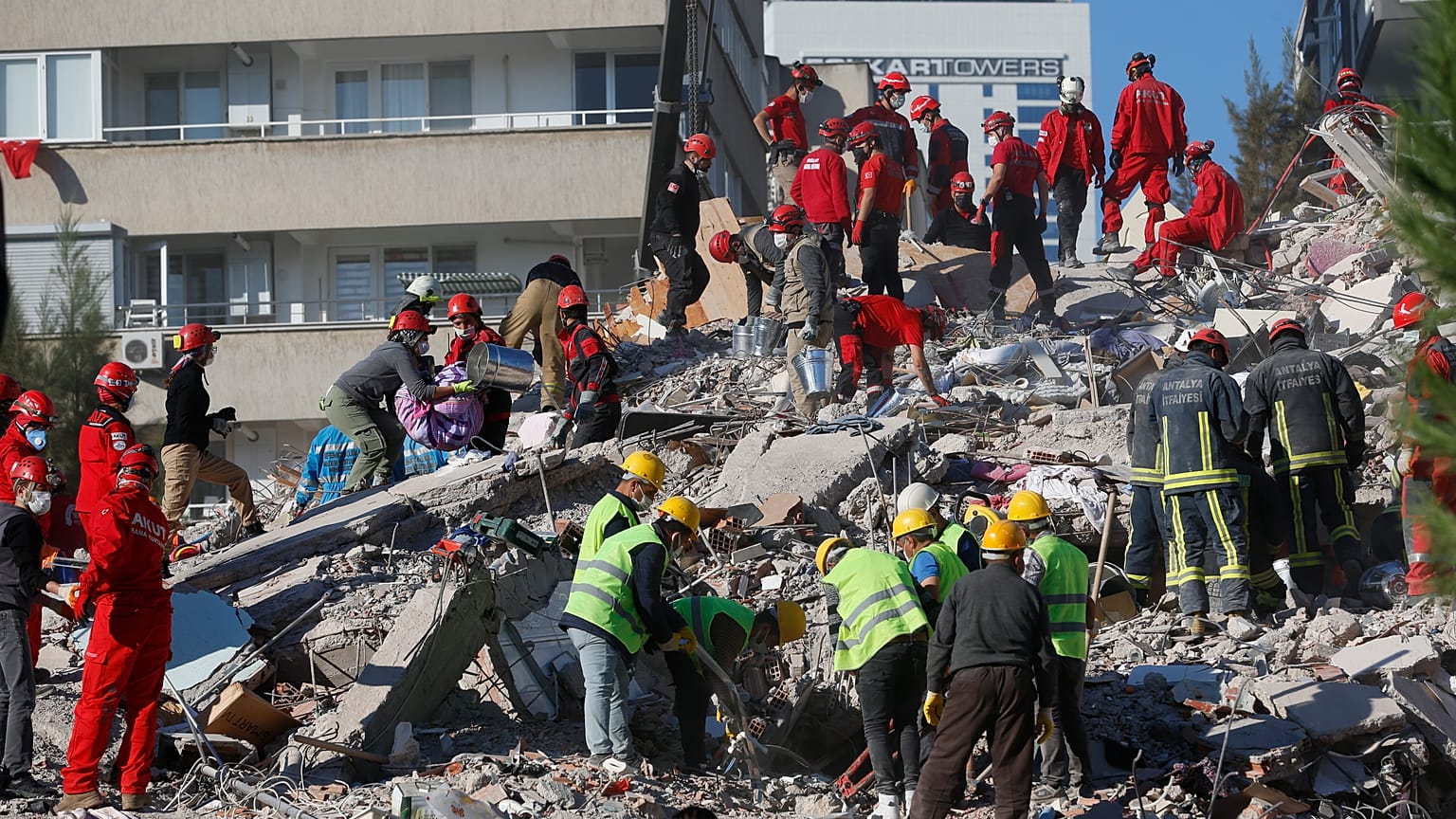 Members of rescue services search for survivors in the debris of a collapsed building in Izmir, Turkey, Saturday, Oct. 31, 2020