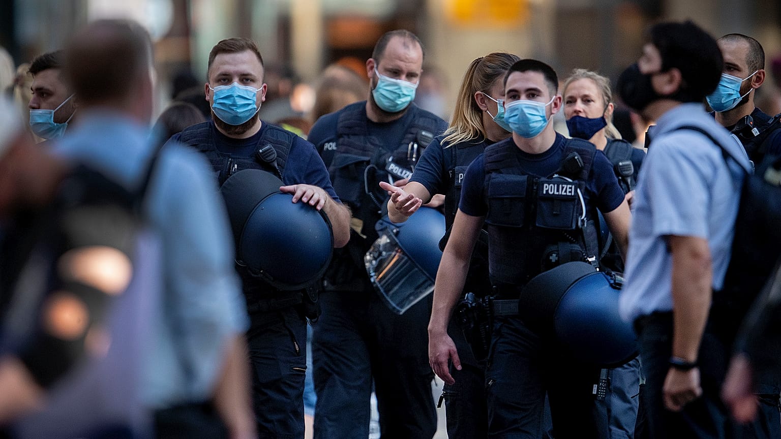 German police officers wear face mask as they walk through the central train station in Frankfurt, Germany, Wednesday, July 22, 2020.