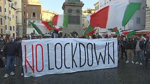 Demonstrators with Italian flags holding banner reading "No lockdown"