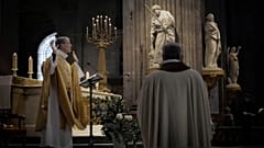 Priest Henri de La Hougue, left, celebrates the All Saints Day mass in Saint-Sulpice church, in Paris, Sunday, Nov. 1, 2020. 