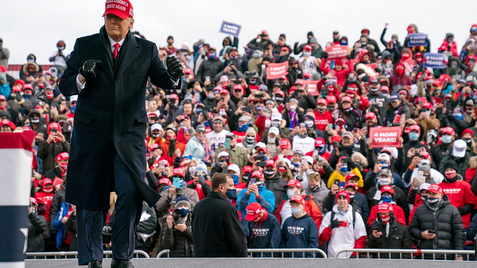 President Donald Trump dances as he walks off stage after speaking during a campaign rally in Washington, Michigan.