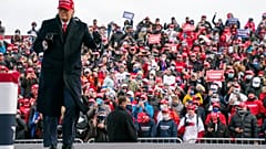 President Donald Trump dances as he walks off stage after speaking during a campaign rally in Washington, Michigan.