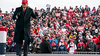 President Donald Trump dances as he walks off stage after speaking during a campaign rally in Washington, Michigan.