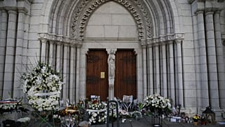 Flowers, messages and candles lie in front of the Notre Dame church after the attack.