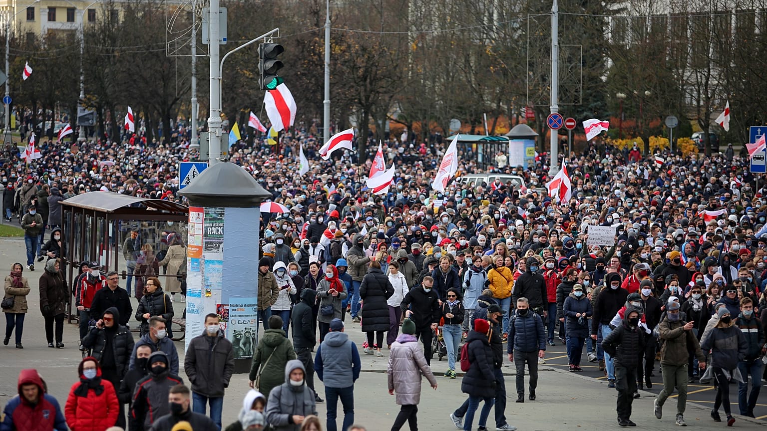 Demonstrators with old Belarusian national flags march during an opposition rally to protest the official presidential election results in Minsk, Belarus, Sunday, Nov. 1, 2020