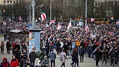 Demonstrators with old Belarusian national flags march during an opposition rally to protest the official presidential election results in Minsk, Belarus, Sunday, Nov. 1, 2020