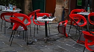 Chairs lie on the ground at the crime scene in a bar in Vienna, Austria, Tuesday, Nov. 3, 2020. 