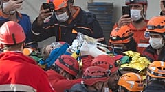 Rescue workers carry four-year-old girl Ayla Gezgin who was buried under rubble for 91 hours following the earthquake