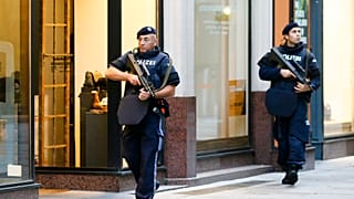 After a shooting armed police officers patrol on a street at the scene in Vienna, Austria, Tuesday, Nov. 3, 2020.