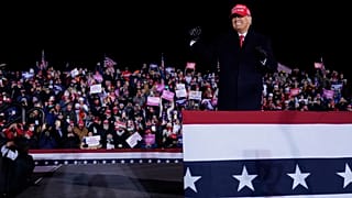 President Donald Trump on stage after a campaign rally at Gerald R. Ford International Airport, early Tuesday, Nov. 3, 2020, in Grand Rapids, Mich. (AP Photo/Evan Vucci)