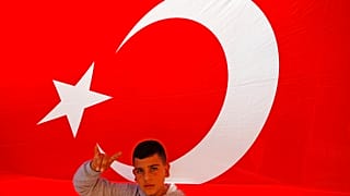 A youth flashes a hand gesture representing the Turkish far-right gray wolves organisation