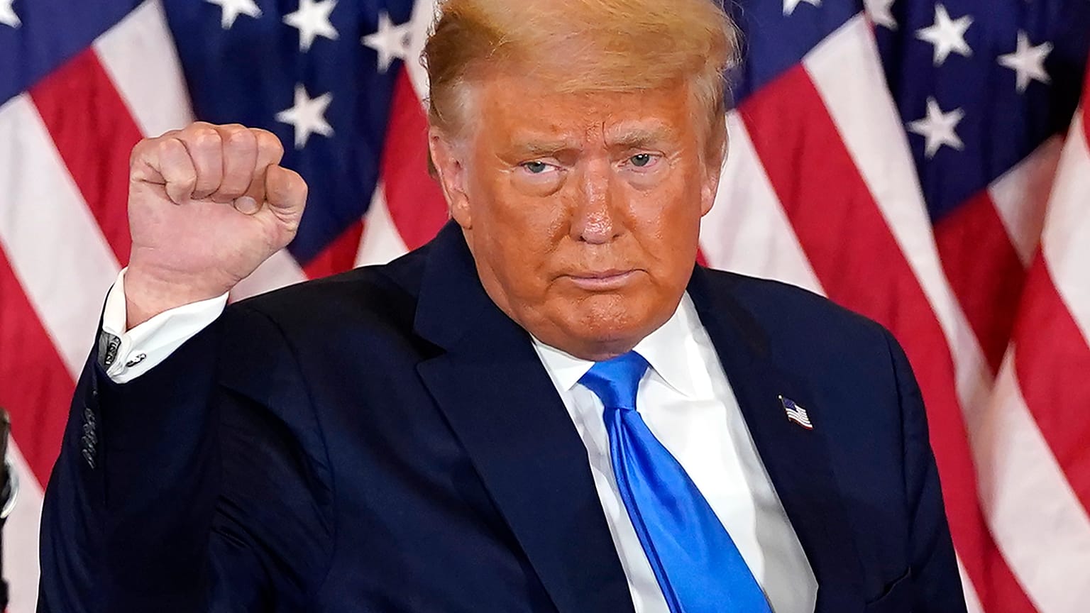 President Donald Trump pumps his fist after speaking in the East Room of the White House, early Wednesday, Nov. 4, 2020, in Washington.