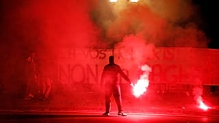 Demonstrators brandish flares and a banner during a protest against restriction measures imposed to curb the spread of COVID-19. Naples, Italy, Oct. 31, 2020