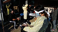 A health worker carries out a rapid coronavirus test at a main popular avenue in Strovolos in capital Nicosia