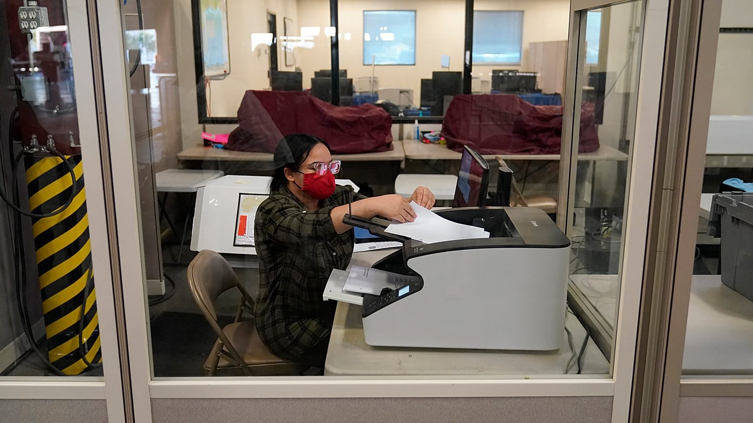 A county election worker scans ballots at a tabulating area at the Clark County Election Department, Wednesday, Nov. 4, 2020, in Las Vegas.