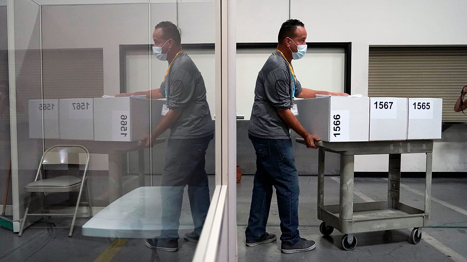 A county election worker moves boxes of counted ballots at a tabulating area at the Clark County Election Department in Las Vegas, Nevada.