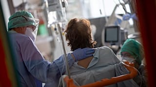 Medical staff provide care to a patient, at the intensive care unit for patients infected by COVID-19 of the university-affiliated hospital (CHU) Cavale Blanche in Brest
