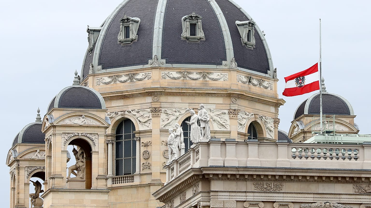 The Austrian national flag waves of half-mast on a building downtown in Vienna, Austria, Wednesday, Nov. 4, 2020