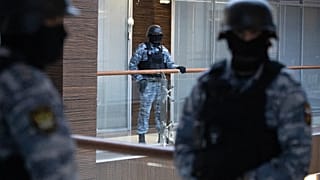 Security officers standing guard at the Alexei Navalny's Foundation for Fighting Corruption office in Moscow, Russia, Thursday, Nov. 5, 2020.