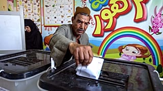 A man casts his ballot at a polling station in El-Ayyat, south of the Egyptian capital on October 24, 2020