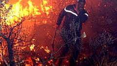An fireman struggles against a fire, late 01 September 2007 night in Tzarift, near Tlemcen, north-west of Algeria.