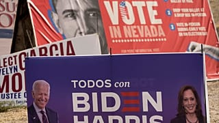 A campaign sign supporting Democratic presidential candidate Joe Biden and running mate Kamala Harris stands in front of a vote sign showing former President Obama.