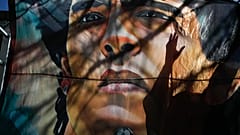 A banner of former soccer star Diego Maradona hangs outside the hospital where he were hospitalized in La Plata.