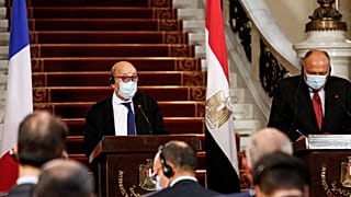 France's Minister of Europe and Foreign Affairs Jean-Yves Le Drian (L) and Egyptian Foreign Minister Sameh Shoukry (R), mask-clad due to the COVID-19 coronavirus pandemic