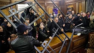 People crash a construction as they broke into the government building protesting against an agreement to halt fighting over the Nagorno-Karabakh region, in Yerevan, Armenia