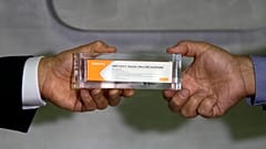 Sao Paulo Governor Joao Doria, left, and Butantan Institute Director Dimas Covas show a box of an experimental COVID-19 vaccine. Sao Paulo, Brazil, Monday, Nov. 9, 2020.