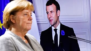 German Chancellor Angela Merkel listens to French president Emmanuel Macron, on the screen, during a virtual news conference with European leaders on terrorism