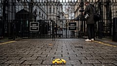 Greenpeace activists hold remote-controlled car race outside London's 10 Downing Street.