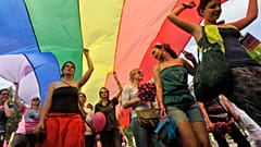 LGBT right activists march with a rainbow flag during the Gay Pride parade in Budapest.